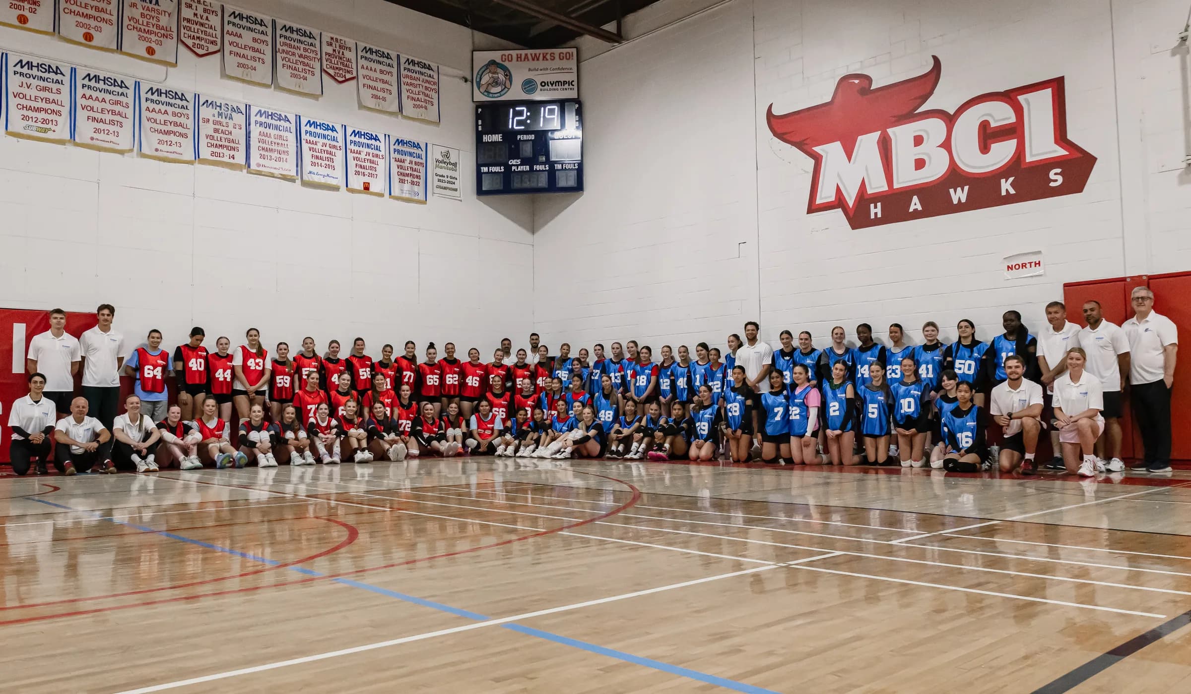 Volleyball athletes and coaches together on the court at MBCI